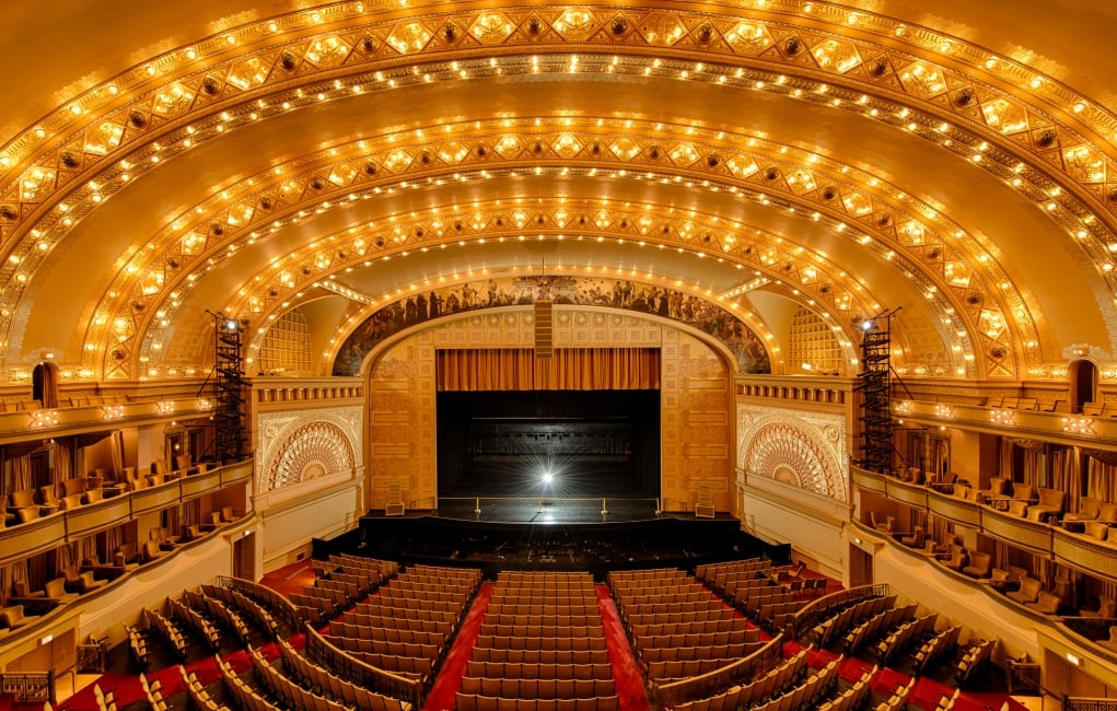 An interior view of a fully illuminated Chicago Theatre.
