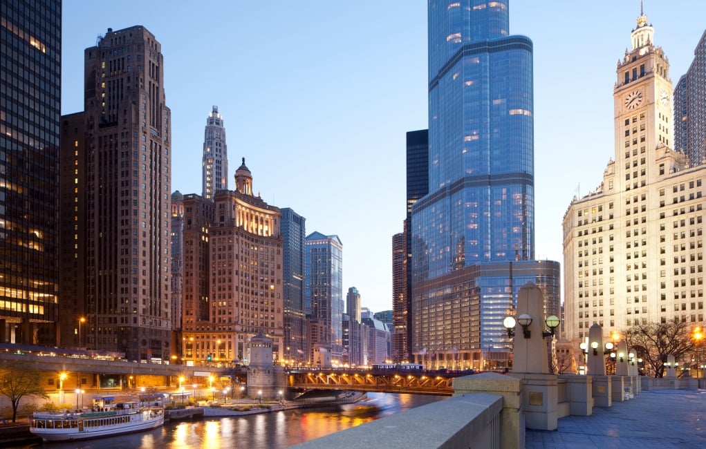 A view of the Chicago River and downtown buildings at dusk.